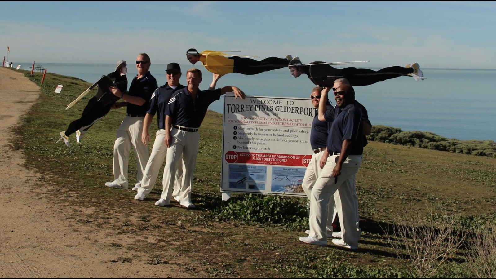 The team holding the flying-golfer drone cutouts at the Torrey Pines Gliderport