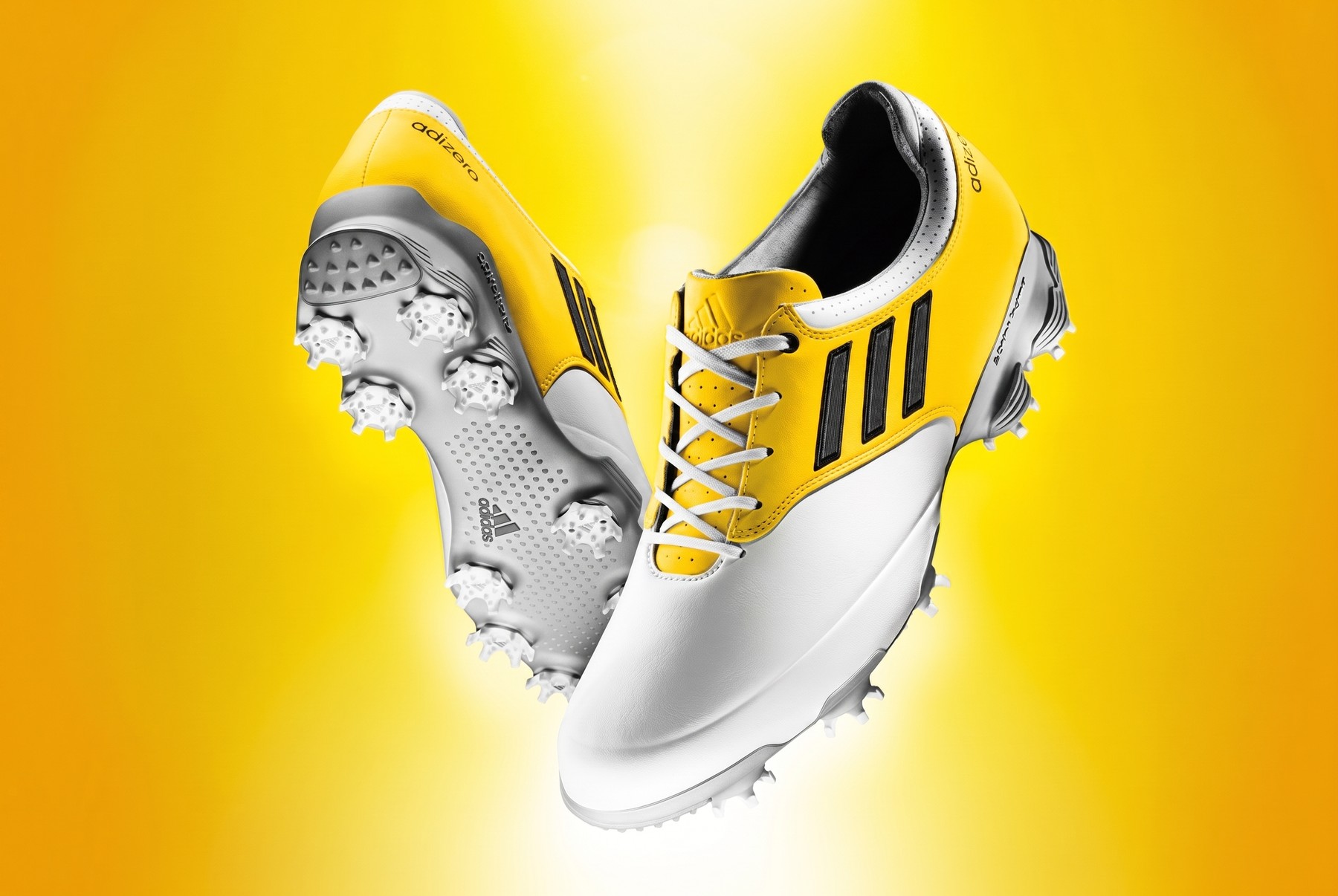 The adidas adizero golf shoe — yellow and white product beauty shot