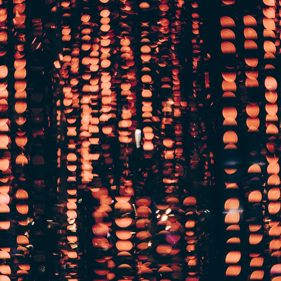 Warm amber pixels rippling across the form
