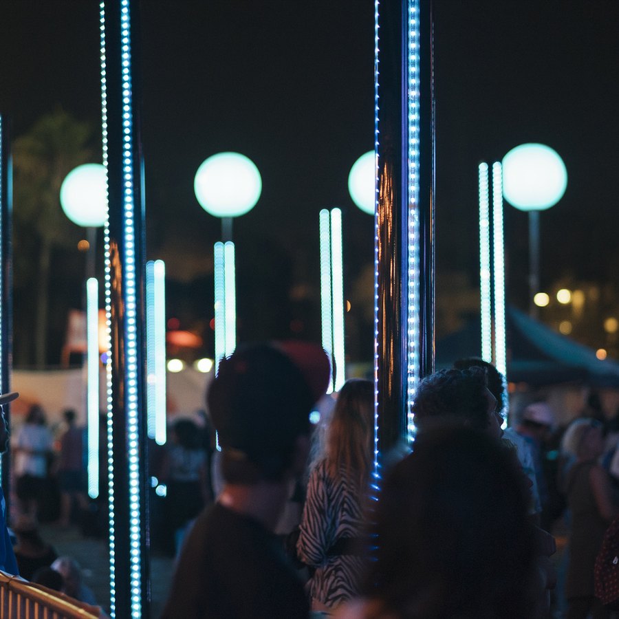 Light columns lining the pier at night